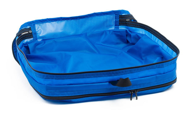 An empty and open Island (blue) Aether Large Aeronaut 45 Packing Cube mesh side up.